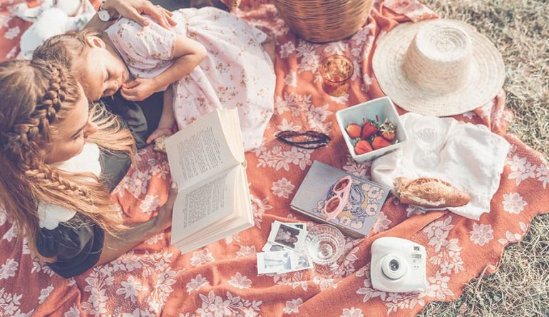 Reading material and a cup of tea on a side table